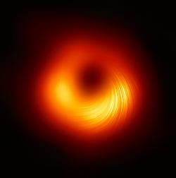 Supermasivní černá díra galaxie M87 v polarizovaném světle, se zřetelnými siločárami magnetického pole. Kredit: EHT Collaboration.