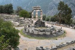 Tholos u pozdějšího Athénina chrámu, 380 až 370 před n. l., za ním základy pokladnic a archaického chrámu Athény. Kredit: Zde, Wikimedia Commons. Licence CC 4.0.