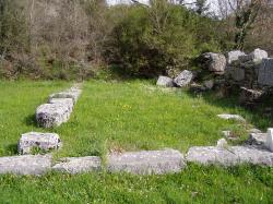 Základy staršího chrámu bohyně Dioné v Dódóně. Vedle zbytky křesťanské basiliky. Kredit: DerHexer, Wikimedia Commons. Licence CC 3.0.