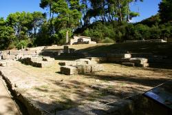 Zbytky chrámu Matky bohů v Olympii, byla míněna Rhea, asi 4. století před n. l. Za ním a nad ním pokladnice. Kredit: stephanemat, Wikimedia Commons. Licence CC 3.0.