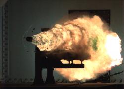 Záběr vysokorychlostní kamerou ze zkoušek prováděných Naval Surface Warfare Center na základně v Dahlgren.  3,2 kg projektil je urychen na 2520 metrů za sekundu. (Kredit:  U.S. Navy)