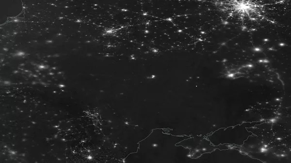 Satelitní snímek ukrajinského blackoutu 23. listopadu 2022. Je vidět, že se Ukrajina téměř úplně ponořila do tmy. (Zdroj NASA).